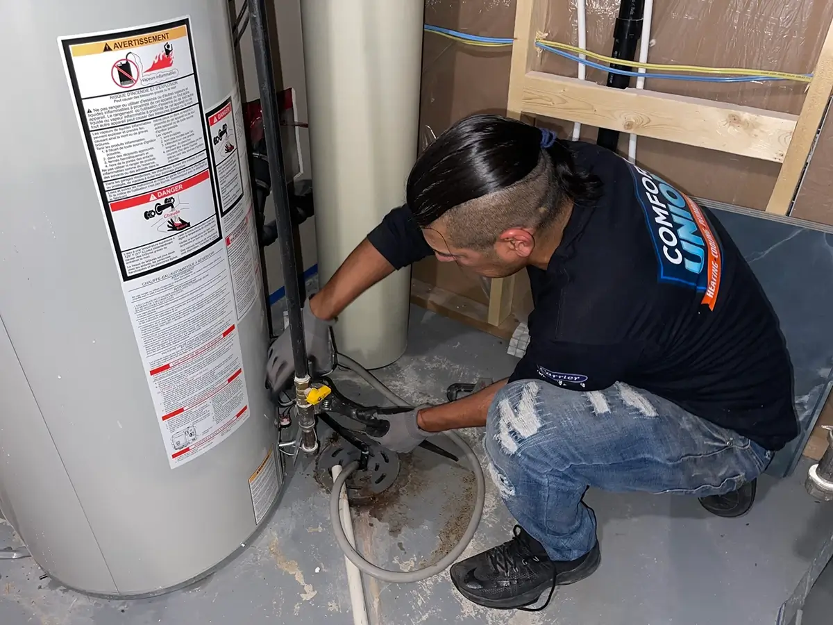 Comfort Union technician performing hot water tank repair to restore safe and efficient service in Airdrie