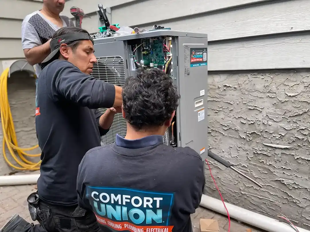 Comfort Union HVAC technician performing A/C maintenance during pre-season promotional offer